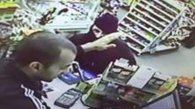 Store surveillance image of  man wanted in armed robbery.