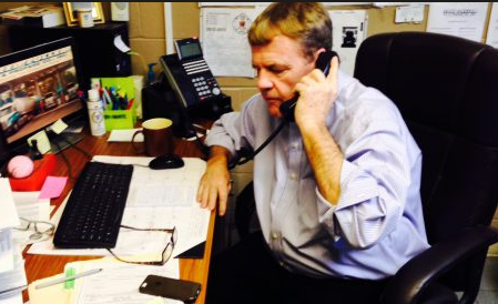 Fred Fuller fields calls in his office in 2013.