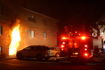 Fire shoots from the first-floor of an apartment building at 65 Log Street on Dec. 21.