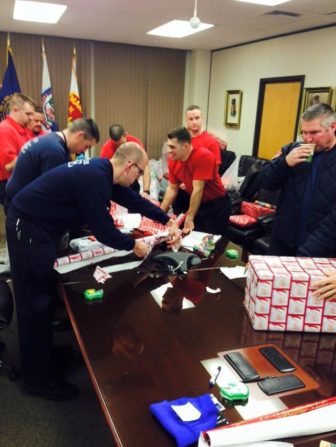 Wrapping Adopt-a-Family gifts at Manchester Fire Department.