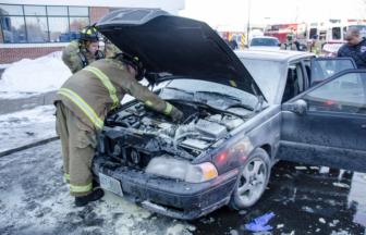 A Manchester firefighter checks out the smoldering engine at the scene of a rescue on Jan. 29.