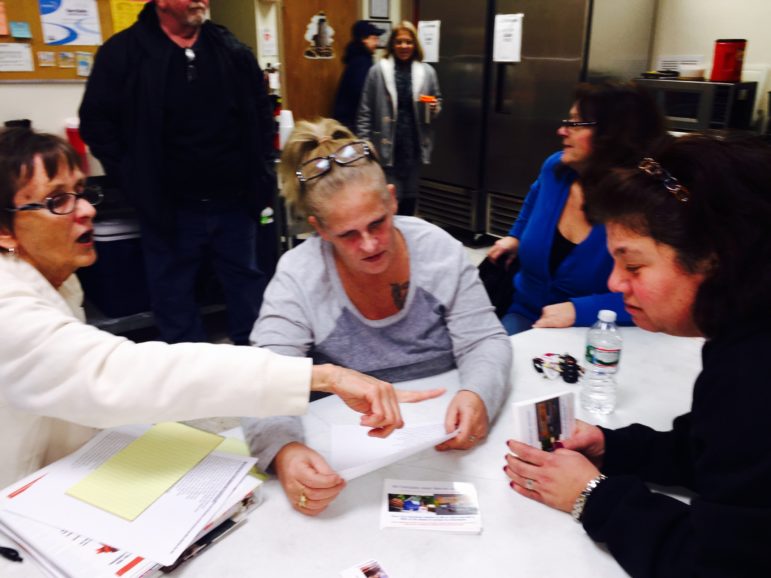 Group leaders Susan Markkievitz, left, and Heidi Sanderson discuss a postcard campaign for a NH law to support Narcan access during a recent TAM meeting in Derry.