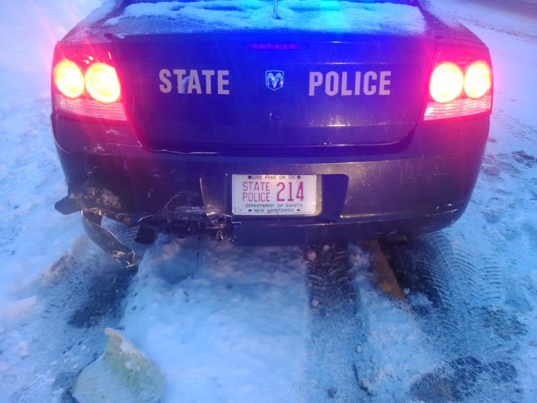 Another view of the damage to the State Police cruiser.