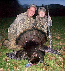 Noah Davis, age 8, with his dad Bob Davis, of Claremont. Noah took his first turkey during a NH youth weekend.