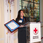 Red Cross Services volunteer Bao Dang accepts the 2013 International Humanitarian Award in Washington, D.C. 