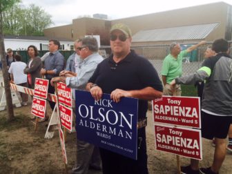 Candidate Richard Olson Jr. holds a sign outside Beech Street School on Special Election Day.