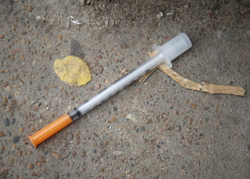 Side issue of heroin: discarded needles in public spaces.