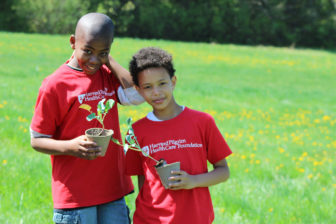 Beech Street Elementary students with broccoli seedings.