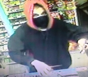 AA Market robbery suspect mugs for the security camera.