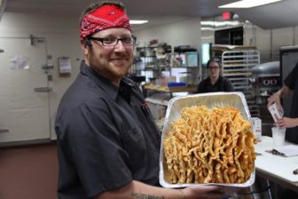Executive Chef Matt Provencher with a local farm delivery, a single Chicken of the Woods