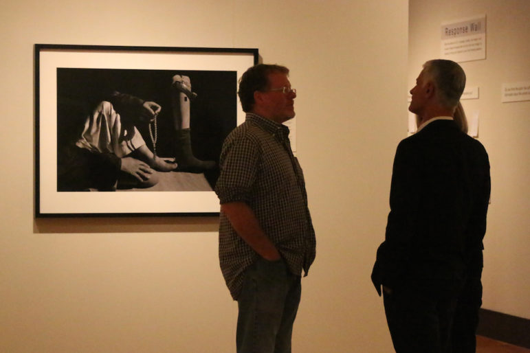 James Nachtwey chats with attendees during a preview of a collection of his photographs, on display at the Currier through Dec. 4.