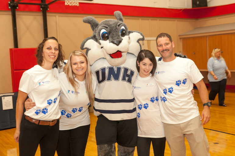 Granite YMCA staffers celebrate wellness with UNH mascot Wild E. Cat.