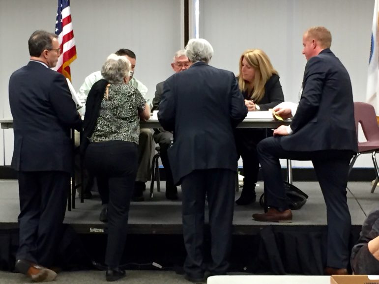 Attorneys for the candidates confer with City Clerk Matthew Normand, right, and the three-member Recount Board after a "glitch" was discovered in the Ward 1 ballot count.