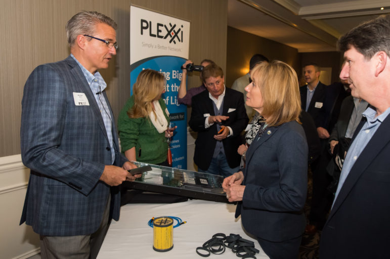 Michael Welts, VP of Marketing for Plexxi, describes his product, The Plexxi Switch 2, to New Hampshire Governor Maggie Hassan as part of the Product of the Year Award product demonstration portion of the event. 