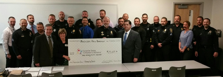 Chief Willard (Center), who is presenting a check to Joy Barrett (holding the check) of Granite State Children’s Alliance, surrounded by a handful of the 125 officers who participated in the Beards for Bucks fundraiser, as well as several GSCA board members. Detective Lieutenant Ledoux is pictured in the faux mustache.