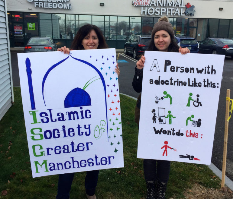 Rouba Balleh, left, and her sister Bana Balleh, worked together on signs to carry in the peace march.