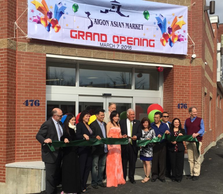 Mayor Ted Gatsas joins Saigon Asian Market owners Thanh Ho and Oanh Nguyen (to the mayor's right, along with family members, bankers and developers for a ceremonial ribbon cutting Feb. 29.