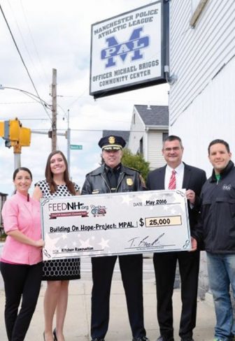 FEEDNH.org donates $25,000 to the Building On Hope project for the Manchester Police Athletic League. Shown left to right: Chef Nicole Barreira, Great NH Restaurants, Tanya Randolph, FEEDNH.org, Manchester Police Chief Nick Willard, Chief David Mara, and Police Officer John Levasseur. The funds are earmarked for the buildings kitchen renovation.