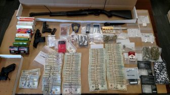 Early morning raid at 366 Massabesic Street yields firearms and drugs.