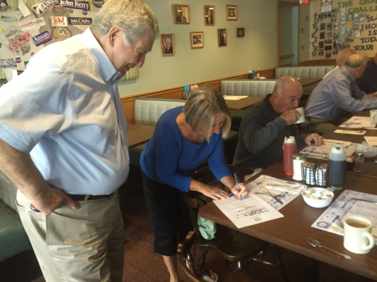 Sen. Lou D'Alessandro gets a signature from Mary Kilrain during a campaign stop at Chez Vachon on June 2.