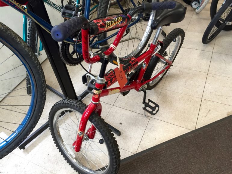 A cool red bike ready for a bike-riding kid.