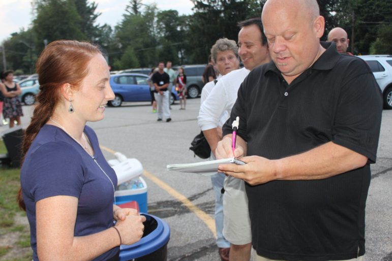 Liza Robert, left, niece of Denise Robert, gets contact information from Daniel Bérubé during the Sept. 3, 2015 vigil for her aunt. Bérubé now serves as Captain of North of Webster Community Group.