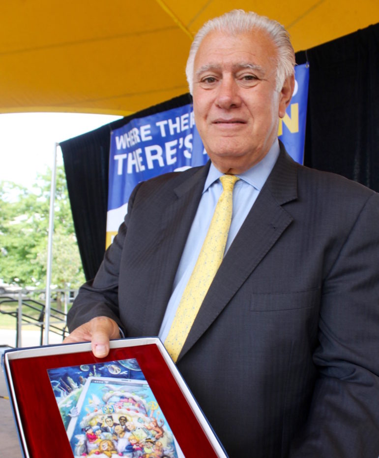 Mayor Ted Gatsas holds the 2016 Peace Poster Plaque, "Share Peace," presented by the Lions International.