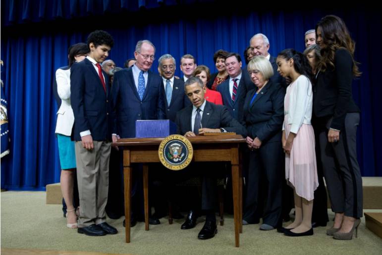 President Obama signs the Every Student Succeeds Act into law on December 10, 2015.