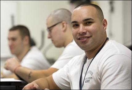 Officer Abdesselam Baddaoui studies in his class at the police station, where he is one of the newest members of the department.