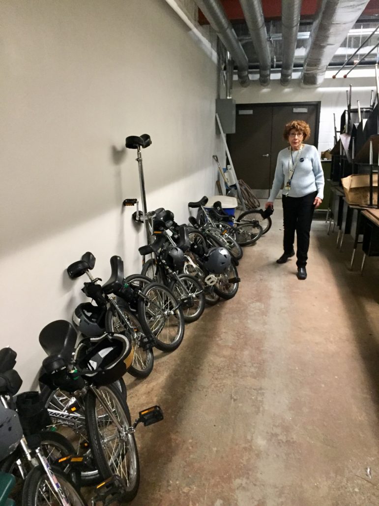 Benita Lebow takes stock of the Beech Street School unicycle fleet.