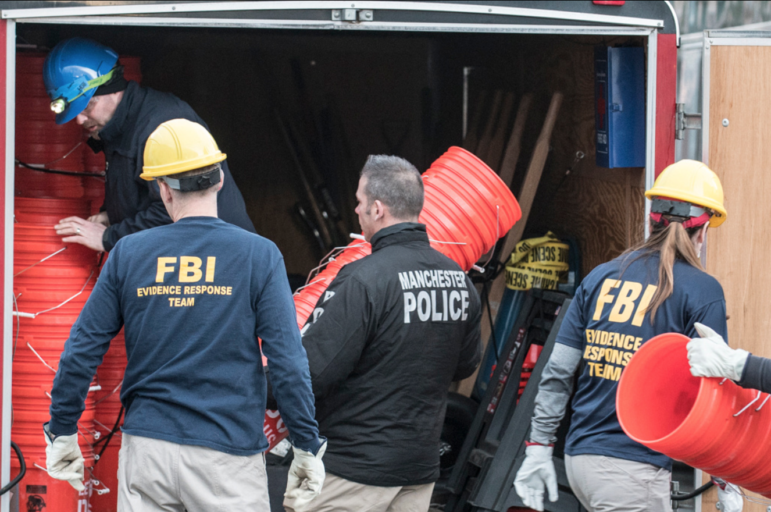 Law enforcement officials, including the FBI, pack up following an on-site investigation on Hayward Street.