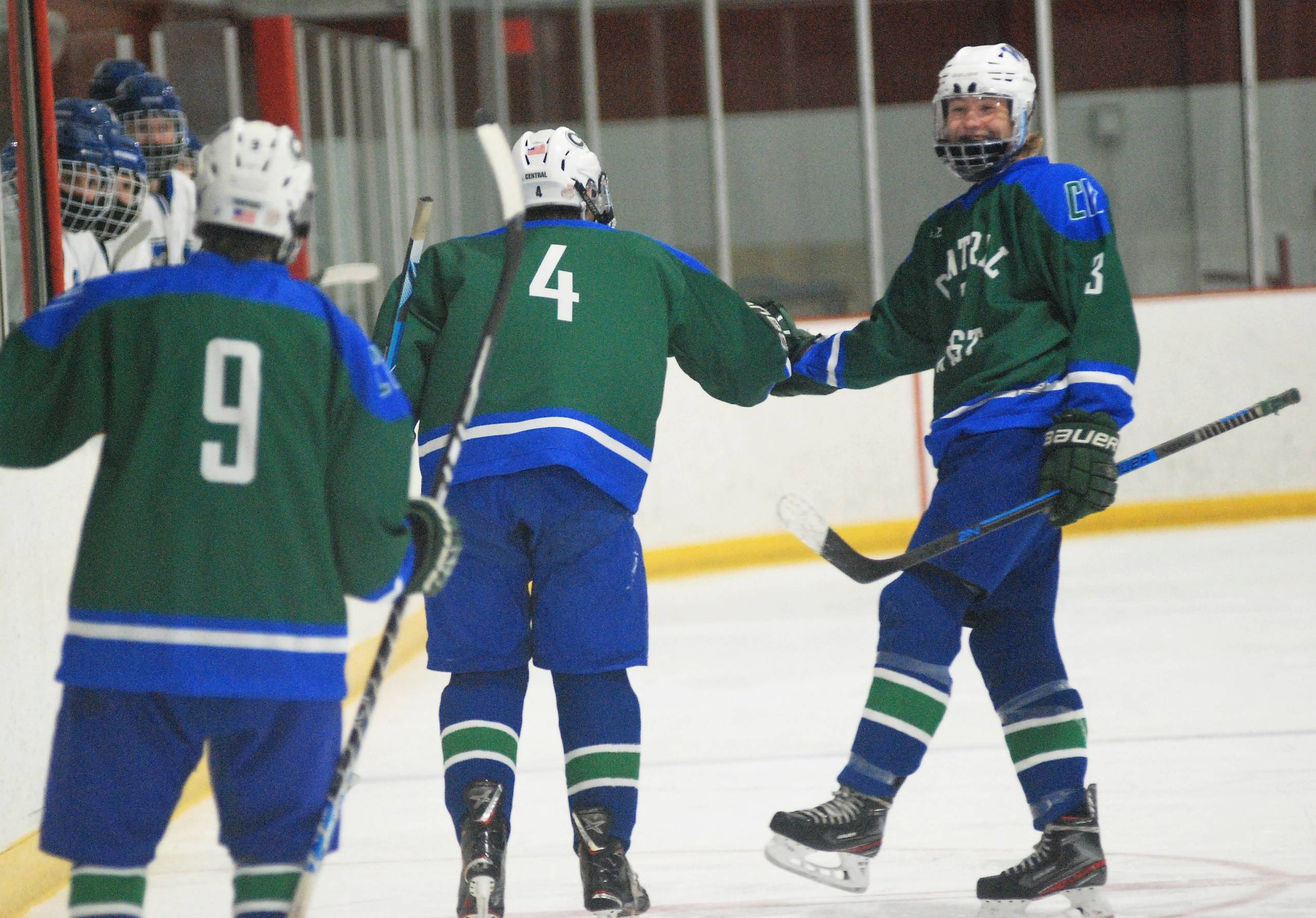 After working through Merrimack's normally tight blue line to score Central/West's second goal of the game, Aiden Owen (no. 4) is congratulated by Owen Kelley, right, while Matt LaForge (no. 9) looks on.