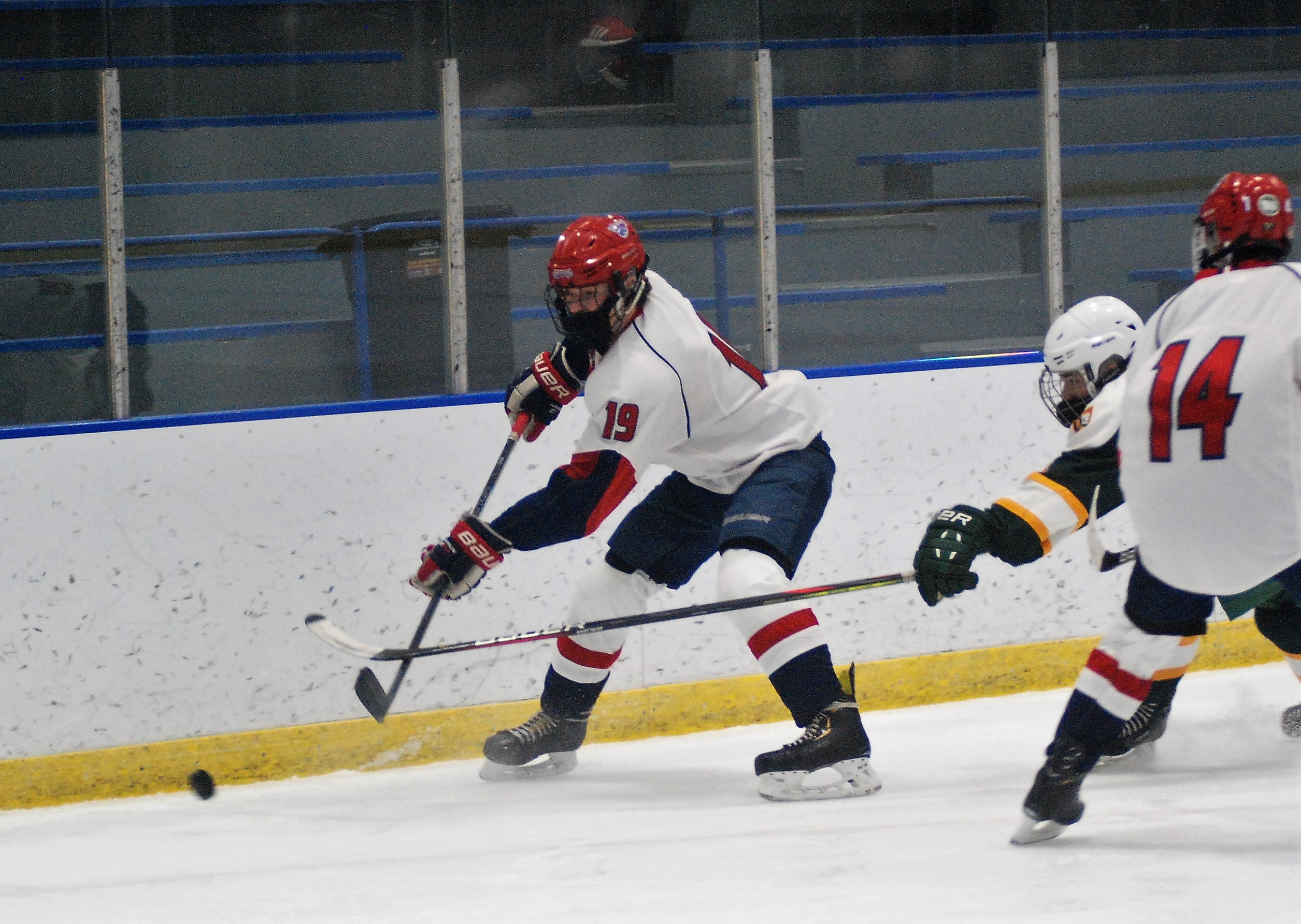 Brandon Murhy knocking the puck away from a defender.