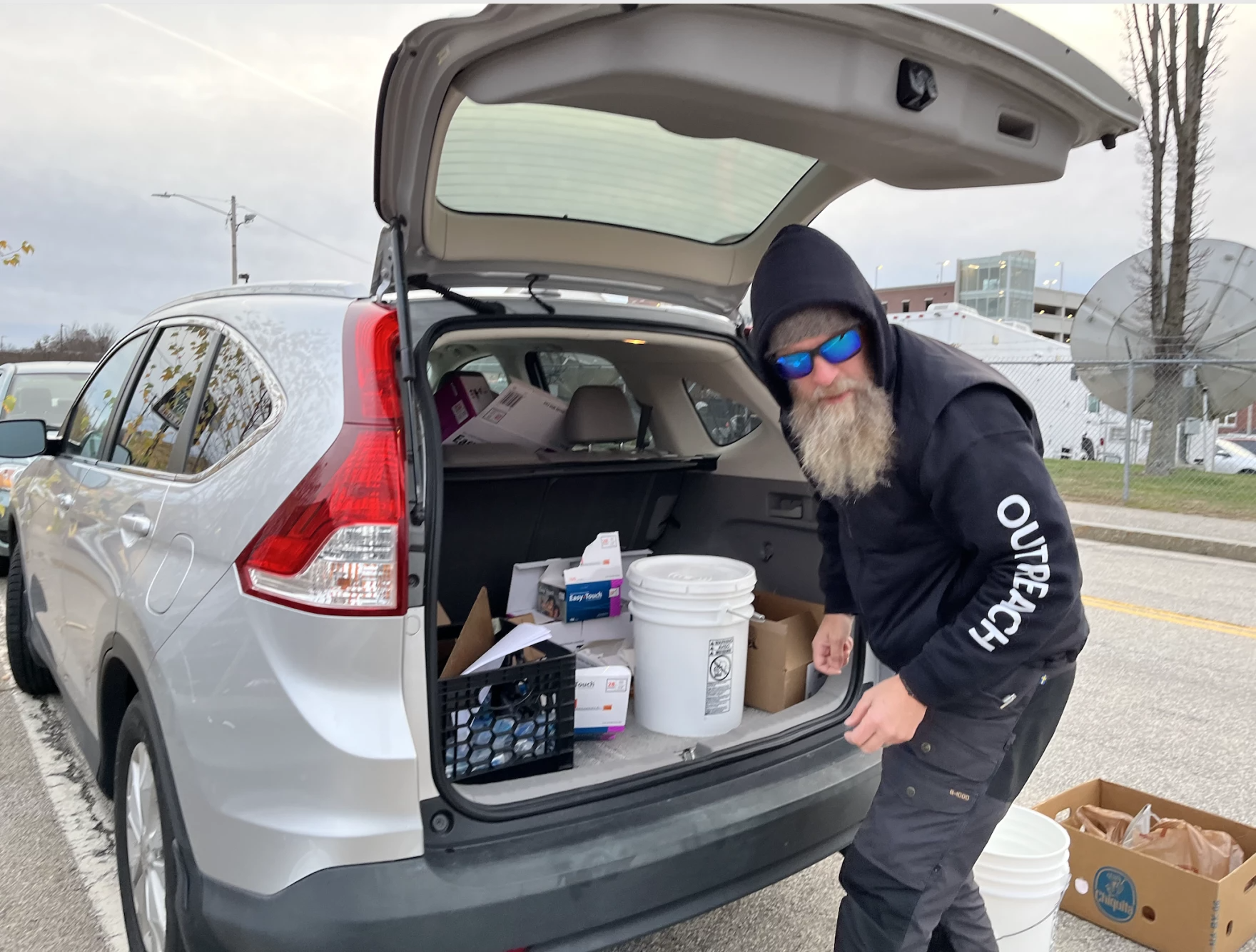 Andrew Warner handing out supplies as part of a syringe exchange program in Manchester in November. Warner, then an outreach worker for the treatment provider Better Life Partners, is now the city's director of overdose prevention.
