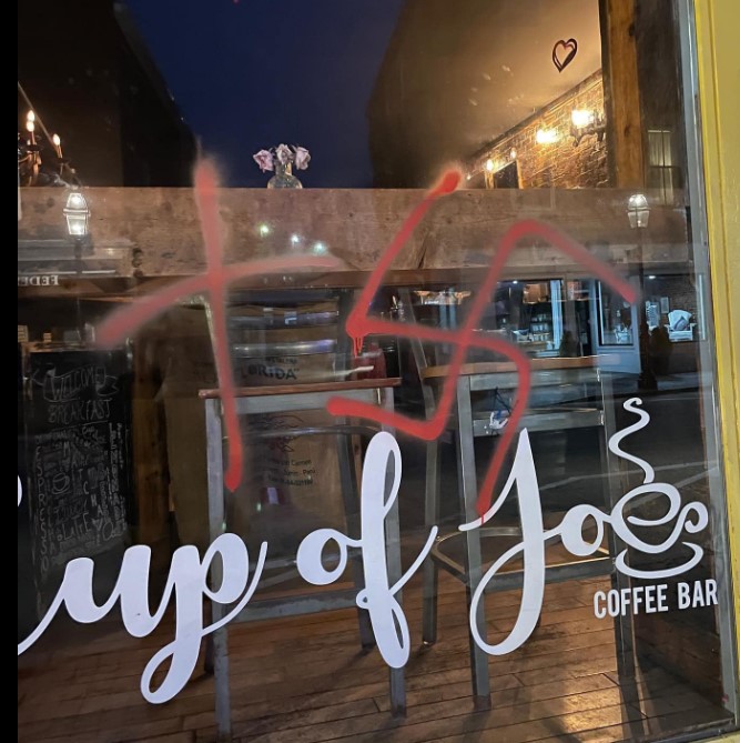 Swastika and a cross were spray painted on the window of Cup of Joe’s Coffee Bar on Market Street on Feb. 21. Portsmouth police photo