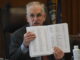 Rick Ladd (R-Haverhill) holds up a list of teacher names and salaries during debate on HB 553. Photo/Andrew Sylvia