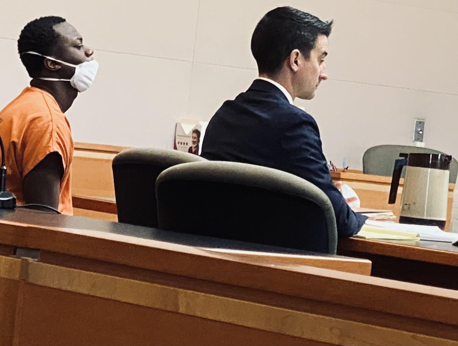 Akwasi Owusu, 21, left, on Tuesday waits for his insanity trial begin in Hillsborough County Superior Court Northern District. At right is one of his public defenders, Tom Stonitsch./Pat Grossmith